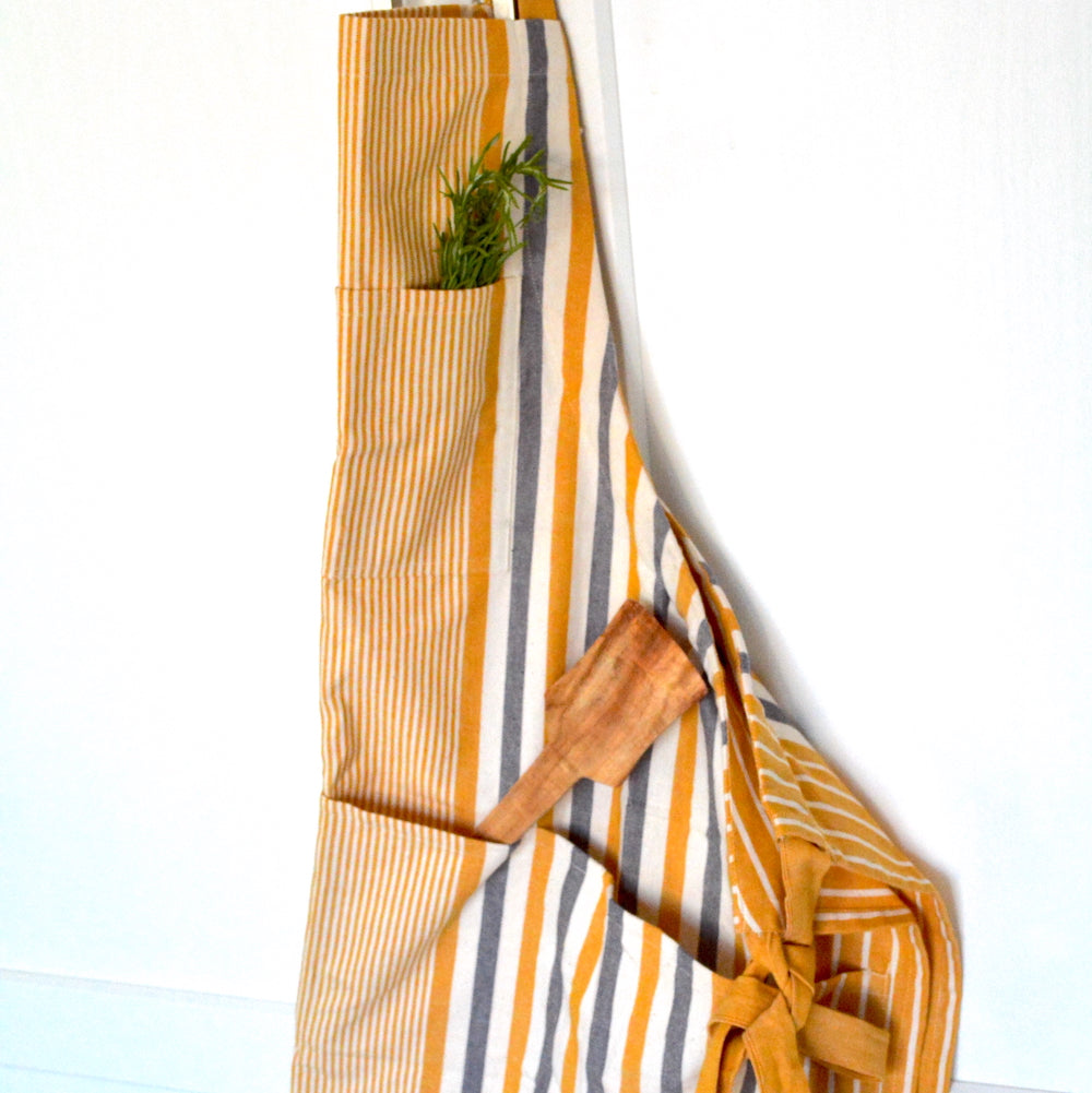 https://www.terraklay.com/cdn/shop/products/TerraKlay-apron-yellow-and-grey-stripes-unisex_1600x.jpg?v=1661476608